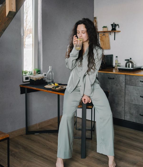 Woman feeling energetic and happy during her morning routine at home.